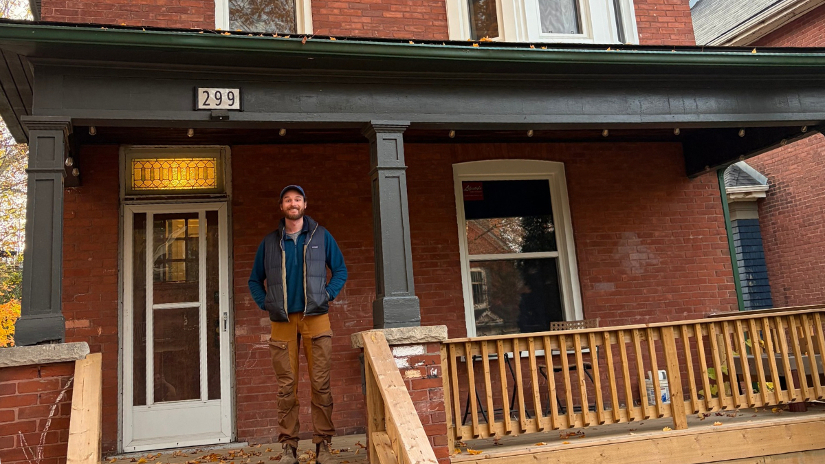 Jordan Detmers stands in front of his retrofitted home